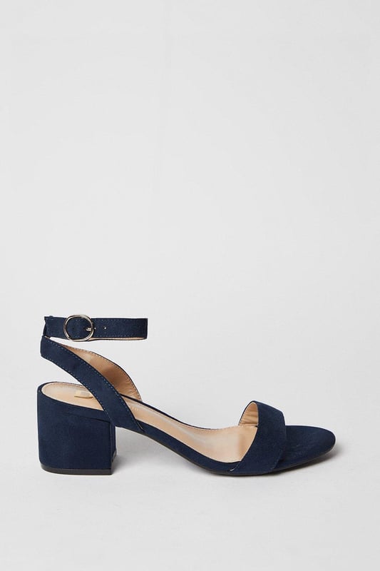 Wide fit design offers a comfortable and accommodating fit
Barely-there strappy silhouette with minimalist appeal
Mid block heel provides a modest lift and walkable height
Faux leather upper exudes a look and feel
Ankle strap with buckle closure ensures a secure fit

These versatile sandals are perfect for casual daytime outings or relaxed evening affairs. Pair them with a flowy midi dress or cropped trousers for a chic, on-trend look that transitions seamlessly from brunch with friends to an evening baby shower. The neutral hue complements a variety of ensembles, allowing you to showcase your personal style effortlessly.