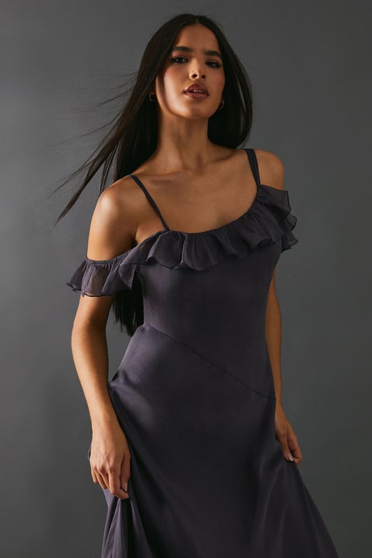 Add a touch of elegance to any occasion. With its embellished asymmetric ruffle and strappy design, it offers a unique and stylish look. The midaxi length adds a modern twist, making it perfect for both casual and formal events.