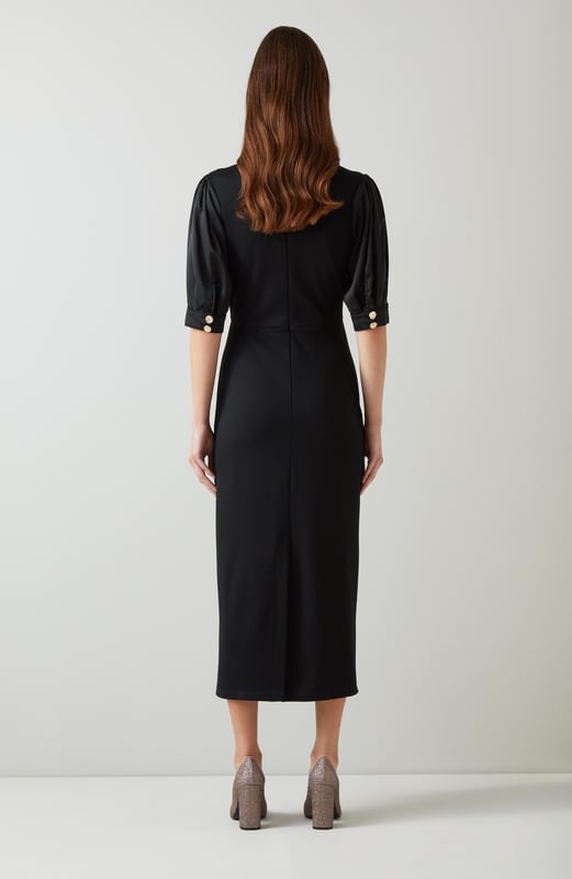 Imagine the perfect blend of sophistication and modern flair. The Daisy crepe dress in timeless black features rib knit trims and dome metal buttons, crafted from luxurious viscose with a stand frill collar and full length sleeves. Pair it effortlessly with ankle boots for a day out or style it with heels for an evening event.