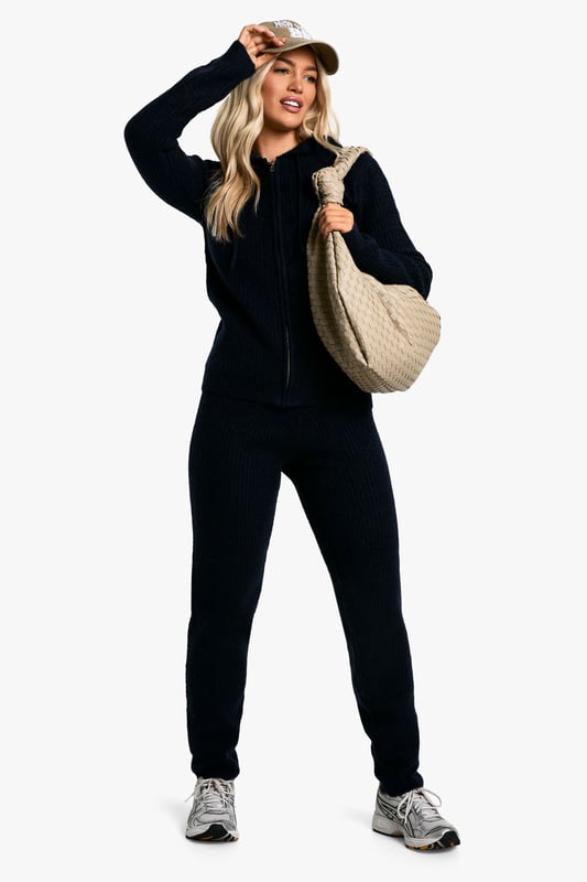 Soft Fine Guage Zip Through Hoody Knitted Tracksuit Soft fine knit fabric for ultimate comfort
Hooded top with full-length zip closure
Coordinating trousers for a complete look
Versatile two-piece set for effortless styling
Relaxed fit perfect for lounging or casual outings
Embrace laid-back chic with this soft fine knit tracksuit. The hooded top with a full-length zip offers both style and practicality, while the coordinating trousers complete the ensemble. Perfect for those lazy Sundays or running errands, this set radiates comfort without compromising on trend. Style it with trendy trainers and a baseball cap for a street-smart look, or throw on some statement jewellery to dress it up for a casual coffee date. The versatility of this co-ord allows for endless styling possibilities - layer with a puffer jacket for cooler days or wear the pieces separately to mix and match with your existing wardrobe. Whether you're heading to the gym, meeting friends for a casual brunch, or simply lounging at home, this tracksuit is your go-to for effortless, comfortable style.