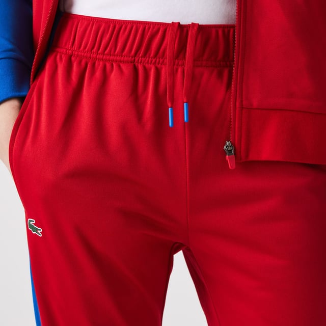 Men's Lacoste SPORT Run-Resistant Tennis Trackpants.- Regular fit, natural ease: The perfect fit for workouts.- Drawstring waist: Customised comfort and fit.- Contrast print on side: The iconic Lacoste colour-block.- Rigid crocodile sewn onto front: Quintessentially Lacoste.- Recycled polyester run-resistant piqué: Lightweight. Environmentally friendly. Material: 100% Polyester. Ref: XH9427W50.
