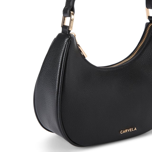 This Carvela Scoop Shoulder Bag features a black exterior with gold branding on the front. Dimensions: 20.5cm (H), 25cm (L), 7cm (D). Strap length cross body: 107cm.