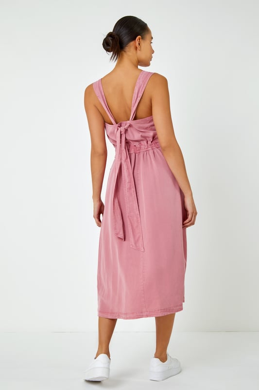 Dyed Strappy Pocket Dress from Roman. It's time to refresh your denim collection by adding this statement detail fit and flare midi dress to your summer wardrobe! This classic feminine piece features a sweetheart halter-neck into back tie detail and front pockets. This timeless one-piece looks great with trainers for an effortless daytime look, alternatively paired with wedges and a sun hat for those stylish city holiday summer breaks abroad.