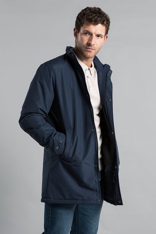 Upgrade your outerwear with Kensington Eastside's mid-length coat. Featuring a funnel neck, zip and button fastening, and a PVC-coated outer, this jacket combines style and durability for any weather.