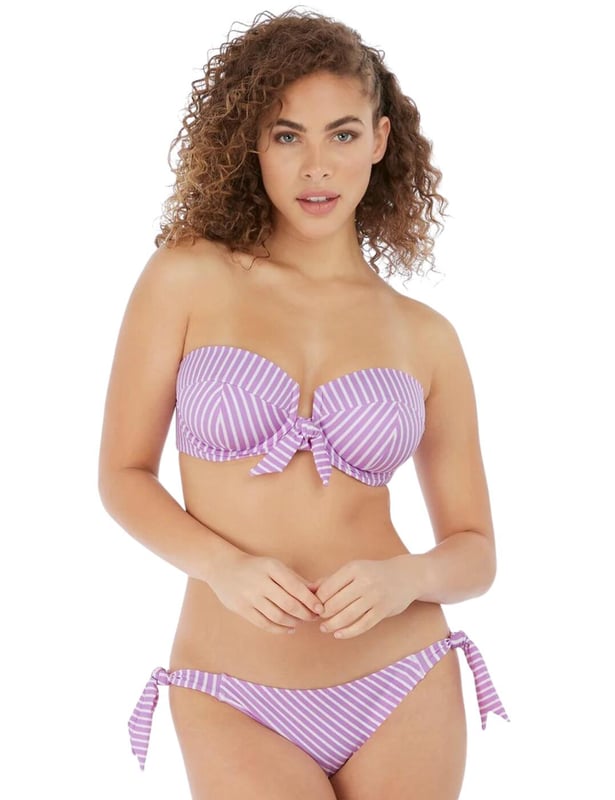 Freya's Beach Hut bandeau bikini top is versatile and chic, with adjustable straps that can be converted from straight to cross-over, or removed for the perfect look no matter what you are doing. The cups are underwired for support and lightly padded, giving your bust a smooth, round shape. The rear clip fastening will stay secure all-day long for worry-free wear. The chic knot detail and open-centre front design add a feminine, flirty touch.  Underwired, Lightly padded, Adjustable straps, Clip fastening, Front knot detail, Open-centre front, Removable, convertible straps, Country of origin: Sri Lanka, Composition: 69% Polyamide | 16% Elastane | 15% Polyester, Listed in UK sizes.   Bandeau Bikini Top