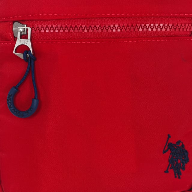 Men's shoulder bag from the U.S. POLO ASSN brand.
 Synthetic material exterior.
 Top zipper closure.
 Zipper pocket on the front and back.
 Back interior: One zipper pocket.
 Adjustable strap with brand print.
 Brand logo on the front.
 Seams seen in tone.
 Measures: 17x20x5.5cm
 Composition: 100% Nylon
 Care:
Clean with a wet cloth.