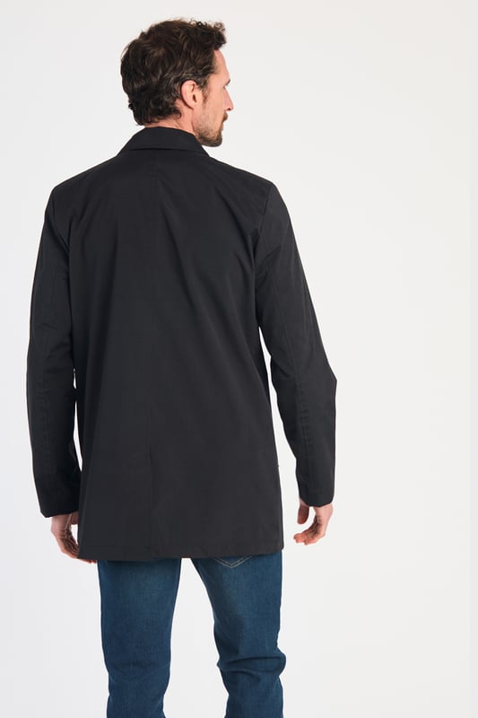 This men's mac-style coat from Kensington Eastside features a classic collar, button-up fastening, and a mid-length cut for a sleek, modern look. Lightweight and stylish, it’s perfect for layering over both casual and formal outfits, making it a versatile wardrobe essential for effortless style.