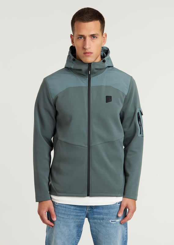 Das Lion Mix ist eine Regular Fit Sweatjacke mit Reißverschluss und gewebter Struktur. Ausgestattet mit einer Nylon-Kapuze, Seitentaschen mit Reißverschluss, einer Ärmeltasche und signature CHASIN'-Details.