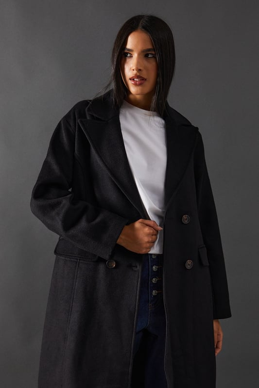 Double-breasted design for a sophisticated silhouette
        Maxi length offering full coverage and dramatic flair
        Wide lapels adding a touch of classic elegance
        Flap pockets for both style and functionality
        Relaxed fit allowing for layering versatility
    
    Make a statement with this striking double-breasted maxi coat from Warehouse. Perfect for the confident woman who appreciates edgy yet feminine style, this coat seamlessly transitions from day to night. The oversized silhouette exudes effortless chic, while the maxi length adds drama to any ensemble. Style it over wide-leg trousers and a chunky knit jumper for a contemporary daytime look. For evening affairs, drape it over a sleek midi dress and pair with heeled boots to create a captivating outfit. The versatile design allows for endless styling possibilities, making it a true wardrobe staple that will serve you well for seasons to come. Whether you're heading to the office or out for dinner, this coat will ensure you arrive in style.
