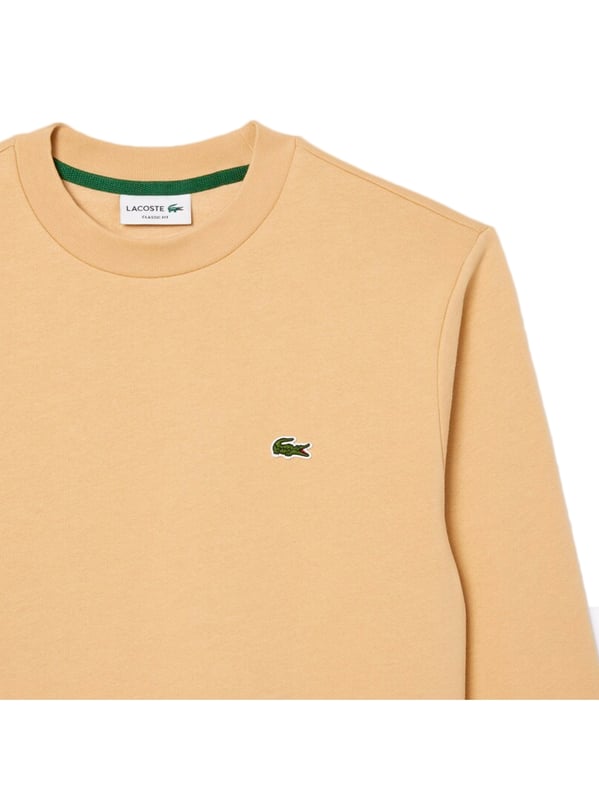Timeless style renewed every season in a new color palette  in our signature details and a sustainable approach. Classic fit  natural ease on body with comfortable sleeves. Solid crewneck sweatshirt in brushed fleece made of organic cotton and recyled polyester. Piqué necktape in iconic Lacoste green. Embroidered 3cm green crocodile sewn on chest.