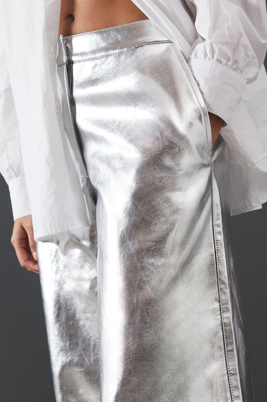 Eye-catching metallic finish for a bold statement
        Wide leg silhouette for a comfortable and trendy fit
        High-waisted design accentuates the waistline
        Front zip and button fastening for a secure fit
        Versatile style suitable for various occasions
    
    Make a dazzling entrance with these striking metallic wide leg jeans from Warehouse. Perfect for those who dare to stand out, these trousers combine comfort with high-impact style. The wide leg cut offers freedom of movement while creating a fashionable silhouette. For a night out on the town, pair these show-stopping trousers with a crisp white shirt, leaving it partially unbuttoned for a relaxed yet chic look. Add some platform sandals to elongate your legs and complete the ensemble with statement earrings. Whether you're hitting the dance floor or enjoying drinks with friends, these jeans will ensure you're the centre of attention. Their versatility also allows for more casual styling - try pairing with a simple black tee and trainers for an effortlessly cool daytime look that transitions seamlessly into evening wear.