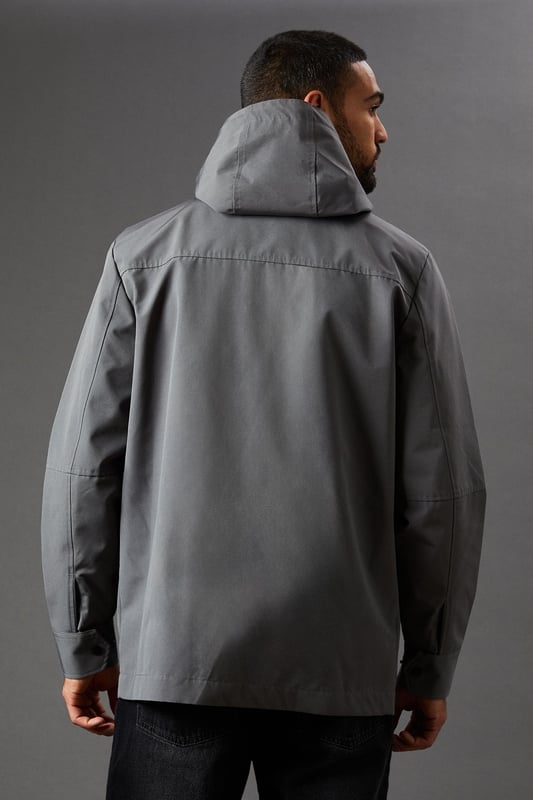 Water-resistant fabric for protection against light rain
        Adjustable hood for customisable coverage
        Full-length zip closure for easy wear
        Practical side pockets for essentials
        Versatile design suitable for various casual occasions
    
    This Burton water-resistant hooded jacket is the perfect companion for the unpredictable British weather. Its sleek design marries functionality with style, making it an ideal choice for the modern man who values both practicality and appearance. The jacket's clean lines and minimalist aesthetic allow for effortless pairing with a variety of outfits. For a smart-casual look, layer it over a light jumper with dark jeans and trainers, as shown in the image. It's equally at home for a weekend walk in the park, a casual day at the office, or meeting mates at the local pub. The adjustable hood and water-resistant fabric offer protection from unexpected showers, ensuring you stay dry and comfortable. Whether you're heading to a football match or running errands around town, this versatile jacket will keep you looking sharp and prepared for whatever the day may bring.