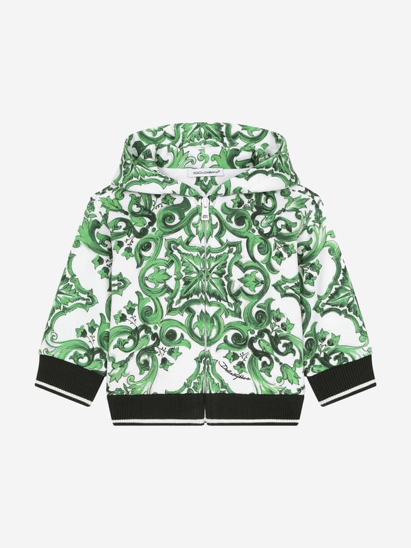 Dolce &amp; Gabbana utilise new technological properties to create captivating aesthetics. This baby boys zip up is a part of the FW24/25 Boy‚ôs Collection that boasts a ‚úcalligraphic-naturalistic‚ù Majolica accent. Crafted in a magnetic two-tone detailing ‚ì bright green and white- cotton jersey design with all-over green majolica print. Inspired by Sicilian tiles, it has ribbed trims and a black script logo on one side. He will be obsessed. ‚ Made in Italy‚ Zip Fastening‚ Machine Wash (30*C)‚ 100% Cotton (Soft Jersey)‚ Lining of Hood: 100% Jersey (Soft Jersey)