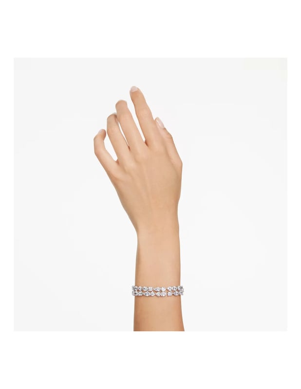This dazzling Bracelet for Women from Swarovski is the perfect gift to spoil yourself or a loved one. The Bracelet is made out of Base Metal, colored Silver at Length: 19.5 cm weighing in at  grams with a Width of 1.4 cm at its widest point. The Swarovski 'Mesmera' Women's Base Metal Bracelet - Silver 5669927 is delivered in a stunning gift box and carries a two year warranty.