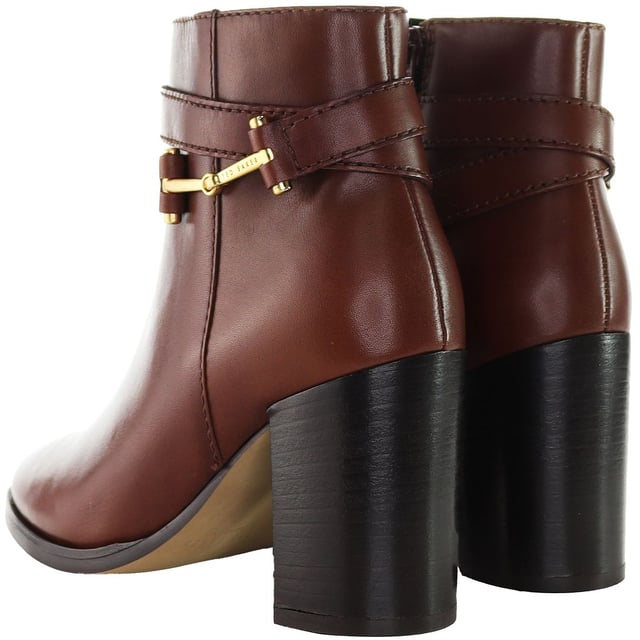 Indulge in the intersection of chic style and contemporary flair with the Ted Baker Anisea T-Hinge Women's Ankle Boots. Elevating your footwear collection with a perfect blend of sophistication and modern design, these ankle boots are sure to make a bold fashion statement.

Key Features:

 T-Hinge Embellishment:  The Ted Baker Anisea Boots feature the distinctive T-Hinge embellishment, a signature element that adds a touch of glamour and uniqueness to the ankle boots. This stylish detail not only catches the eye but also reflects Ted Baker's commitment to intricate design.

 Ankle Boot Silhouette:  Embrace a sleek and versatile silhouette with these ankle boots. The shorter height allows for easy pairing with a variety of outfits, making them a versatile choice for both casual and more formal occasions.

 Comfortable Fit:  Experience comfort without compromising style. The Anisea Boots are designed to provide a snug and comfortable fit, allowing you to walk with confidence throughout the day.

 Side Zipper Closure:  Effortlessly slip into these ankle boots with the convenient side zipper closure. This practical feature not only ensures easy on-and-off wear but also maintains the clean lines of the design.

Step into a world of fashion-forward elegance with the Ted Baker Anisea T-Hinge Women's Ankle Boots â€“ a perfect choice for those who appreciate distinctive design, luxurious materials, and versatile styling options. These boots effortlessly embody the essence of Ted Baker's commitment to timeless yet contemporary footwear.
