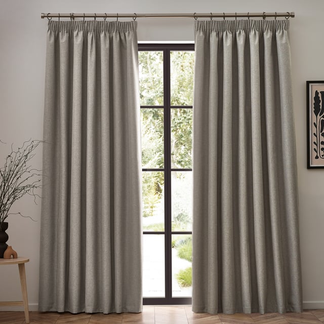 Transform your living space with Dawn Blackout Pencil Pleat Curtains, designed for those who value elegance and practicality. Crafted from soft-textured fabric with a modern marl effect, these curtains add refined style to any room while effectively blocking out light. Perfect for a restful night's sleep or creating the ideal movie-watching environment, their temperature-regulating properties ensure comfort year-round by keeping your home cool in summer and warm in winter. Enjoy the perfect blend of function and style with Dawn Blackout Curtains.
