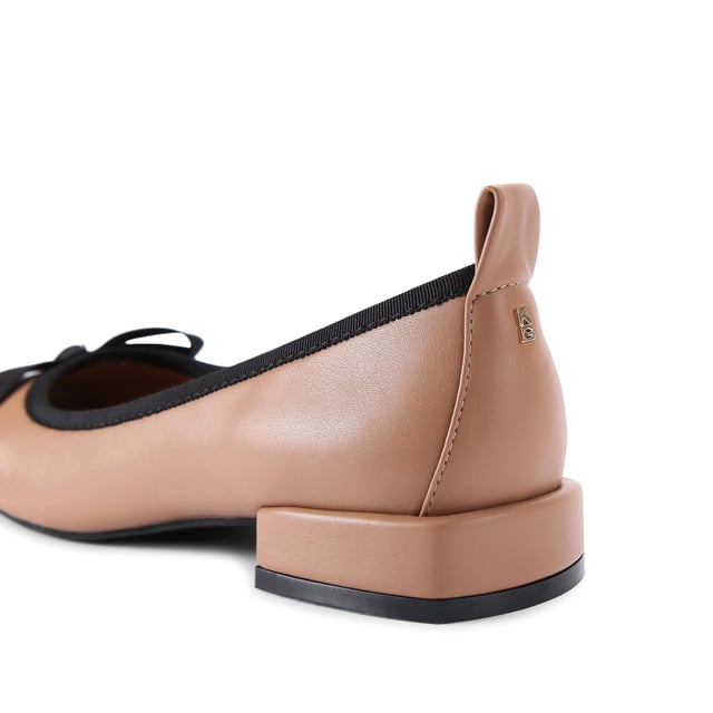 The KG Kurt Geiger Marvyn is a camel ballet flat with black bow on the toe and flat block style heel.