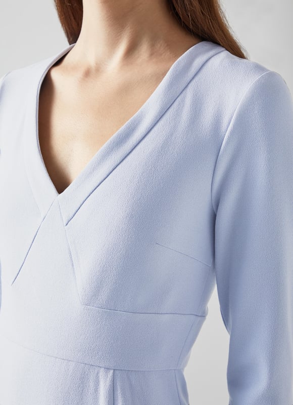 Beautifully tailored, totally timeless and kind to our planet, the new Sky shift is designed with dressy days in mind, because we all need that one dress that can do it all. Thoughtfully-made in Europe from a pale blue LENZING™ ECOVERO™ viscose* blend crepe, it's a shapely shift with a deep V-neck, three-quarter sleeves with flared cuffs, a nipped waist and a pencil skirt with slit detail. Wear it with courts and a tote for the office or with heels and a clutch for the fancier moments in your spring diary. 

*More about the fabric
LENZING™ ECOVERO™ viscose uses up to 50% less emissions and 50% less water than standard viscose. This fibre relies on wood pulp, and is crafted from sustaibly maged tree species such as beech, spruce and eucalyptus.