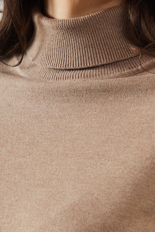Asymmetric hem design for a modern twist
        Cosy roll neck for extra warmth and style
        Contrasting cuffs add a unique touch
        Relaxed tunic silhouette for comfort
        Versatile knitted fabric suitable for various occasions
    
    This Roll Neck Asymmetric Hem Tunic from Wallis is the epitome of sophisticated comfort. The asymmetric hem creates a flattering silhouette, while the roll neck offers both warmth and elegance. Perfect for those who appreciate a touch of glamour in their everyday wear, this tunic can be styled for various occasions. Pair it with wide-leg trousers and ballet flats for a chic daytime look, or dress it up with tailored trousers and heeled boots for evening gatherings. The contrasting cuffs add a subtle yet striking detail, making this piece stand out in your wardrobe. Whether you're attending a family lunch or meeting friends for coffee, this versatile tunic will keep you looking polished and feeling comfortable throughout the day.