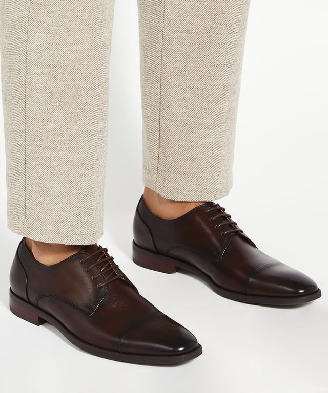 Dune Mens Suffix - Leather Toe Cap Lace Up Derby Important date in the diary? Our timeless lace-up Derby has been designed for those who need to maintain a polished appearance without compromising on comfort. Crafted from smooth, burnished premium leather and boasting a low-block heel and toe cap, this versatile design is guaranteed to enhance every smart outfit. Thanks to the soft cushioning and ergonomic design that supports your feet all-day- long, this hybrid profile will allow you to transition seamlessly from meetings to social events. The flexibility in the sole allows for natural foot movement, reducing strain during long hours of we