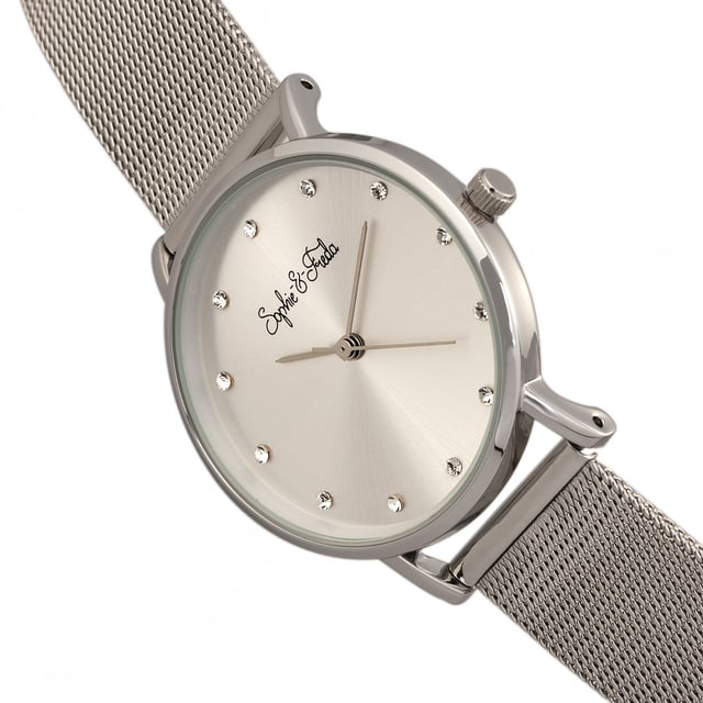 Polished Alloy Case ; Precision Japanese Quartz Movement ; Non-Glare Scratch-Resistant Mineral Crystal ; 12 Swarovski Crystal Markers on Dial; Logo-Engraved Stainless Steel Caseback ; Mesh Alloy Bracelet; Box with Tongue and Safety Clasp; 32mm Case Diameter ; 3 ATM Water Resistance;