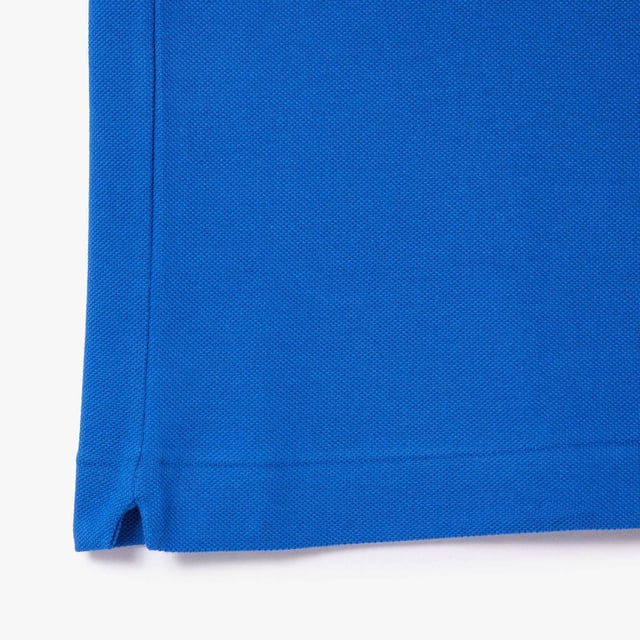 inchLacoste  inventor of the polo since 1933 Original L.12.12 Polo. Made by Lacoste. The Icon. Collar  button placket  petit piqué fabric - these are the components thought by René Lacoste. Yes  René did it first. 90 years ago  he challenged the status quo by creating the first polo to bring more freedom of movement on and off court. And put a crocodile at heart  making Lacoste the first brand who put a logo on clothing. Classic fit  comfortable ease on body and sleeves Original L.12.12 polo in our iconic petit pique renewed every season in a new large color palette. The Petit Piqué fabric is a Lacoste signature. It made of fibers knit together at two different levels of tension. The result? A finely honeycombed fabric that enables air to circulate freely. This fabric ensures comfort  ease of movement and elegance. Ribbed collar and cuffs Side slits Invisible hem Real mother of pearl buttons 3cm green crocodile at chest inch.
