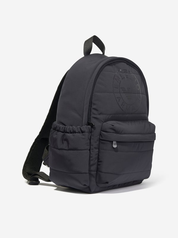 Elevate your young one's style with the Emporio Armani Boys Logo Backpack in Navy (37cm). Crafted for the AW2024 season, this chic piece blends functionality with high-end fashion aesthetics. Perfect for school or weekend adventures, here's why it's essential:‚ Iconic Armani Logo: Features the esteemed Emporio Armani logo, synonymous with luxury and quality.  ‚ Premium Navy Blue Fabric: High-quality material ensures durability and longevity.  ‚ Ergonomic Design: Adjustable straps and lightweight structure offer comfort and support for all-day wear.  ‚ Versatile &amp; Stylish: Timeless navy hue complements various outfits, elevating your boy's fashion game.Gift a touch of designer elegance to your young one's essentials. Get the Emporio Armani Boys Logo Backpack today!