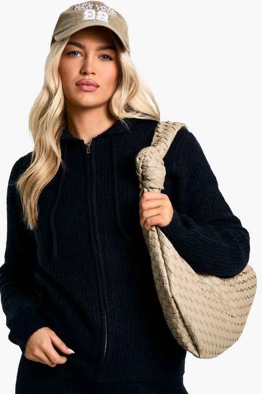 Soft Fine Guage Zip Through Hoody Knitted Tracksuit Soft fine knit fabric for ultimate comfort
Hooded top with full-length zip closure
Coordinating trousers for a complete look
Versatile two-piece set for effortless styling
Relaxed fit perfect for lounging or casual outings
Embrace laid-back chic with this soft fine knit tracksuit. The hooded top with a full-length zip offers both style and practicality, while the coordinating trousers complete the ensemble. Perfect for those lazy Sundays or running errands, this set radiates comfort without compromising on trend. Style it with trendy trainers and a baseball cap for a street-smart look, or throw on some statement jewellery to dress it up for a casual coffee date. The versatility of this co-ord allows for endless styling possibilities - layer with a puffer jacket for cooler days or wear the pieces separately to mix and match with your existing wardrobe. Whether you're heading to the gym, meeting friends for a casual brunch, or simply lounging at home, this tracksuit is your go-to for effortless, comfortable style.