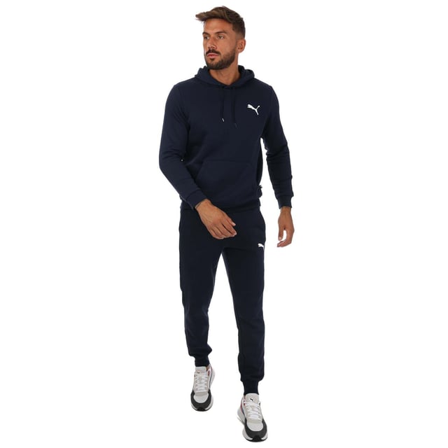 Mens Puma Essentials Logo Sweatpants in navy.- Elasticated waist with inner drawcord.- Two front pockets.- Ribbed ankle cuffs.- Printed branding.- Brushback fleece.- Regular fit.- Shell: 66% Cotton  34% Elastane. Rib: 97% Cotton  3% Elastane.- Ref: 58671476