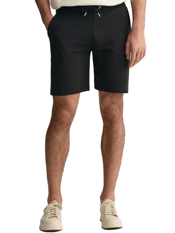 These classic sweat shorts are crafted from a soft cotton blend and tailored for a regular fit. Featuring a ribbed waistband for enhanced comfort, the design includes two front pockets, a single back pocket, and a drawstring waist. Completing the look, the shorts are adorned with a small-scale shield graphic embroidered on the left leg.