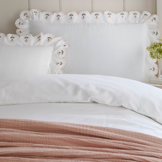Indulge in the timeless charm of the Florrie Embroidered Cotton Duvet Cover Set, where refined craftsmanship meets effortless comfort. Made from 100% soft cotton percale, it offers a luxurious yet breathable finish, ensuring a restful night’s sleep. The elegant scalloped trim, adorned with intricate embroidery and floral details, brings a touch of understated heritage to your space, making it a perfect blend of classic and contemporary. Its sophisticated design invites layering with textured throws and cushions, creating a serene, cosy retreat that feels both fresh and inviting. Elevate your bedroom with a piece that feels as special as it looks.