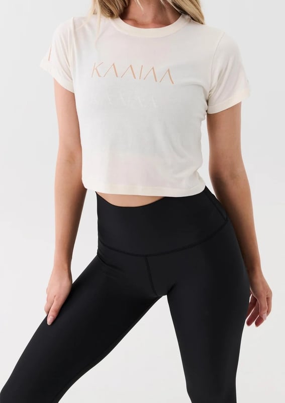 Slightly relaxed fit tee in a cropped length. Fine ribbed neckline. KAAIAA flat rubber logo and P.E Nation flat rubber logo on sleeve