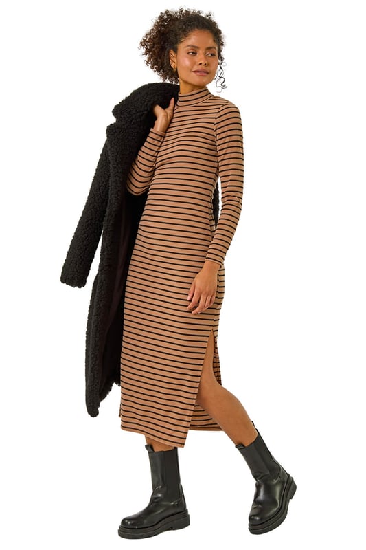 High Neck Stripe Bodycon Midi Dress from Roman. Elevate this Autumn Winter with our midi dress adorned in a timeless stripe print. Designed to finish at midi length, this dress showcases a flattering bodycon shape, complete with a high neckline and long sleeves to keep you warm throughout the colder season. Crafted from a cosy ribbed fabric, this dress is an essential to stay both stylish and comfortable. Pair it effortlessly with a denim jacket and boots for a complete fall look.