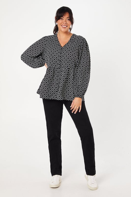 Striking geometric print for a modern, eye-catching look
        Button-through front design for easy wear and versatility
        Flattering peplum silhouette to accentuate the waist
        Voluminous long sleeves for a touch of drama
        V-neckline to elongate the neck and add a feminine touch
    
    This Dorothy Perkins peplum top radiates contemporary charm with its captivating geometric print. The button-through design offers both style and practicality, allowing for effortless dressing and the option to adjust your look. The peplum silhouette gracefully cinches at the waist before flaring out, creating a flattering shape for various body types. Style this versatile piece with slim-fit trousers and white trainers for a chic daytime ensemble perfect for brunching with friends or attending a casual family gathering. For a more polished look, pair it with dark tailored trousers and ballet flats, ideal for those days when you want to feel put-together without compromising on comfort. The long, billowy sleeves add a touch of drama, making this top a standout choice for your wardrobe that transitions seamlessly from day to night.