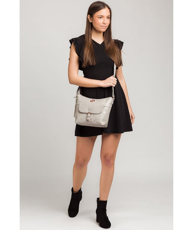 The 'Monamy' shoulder bag from Pure Luxuries London is handcrafted from beautiful leather for a luxuriously smooth finish. Concealed under a zip-over top is a 100% natural cotton lining complemented by two slip pockets, perfect for storing your phone and keys. A mock-buckle secures a magnetic fastened pocket alongside rear slip pockets that are ideal for on-the-go storage. Comes with a slimline strap that has a drop length of 65cm and is adorned with the reinvented rose gold Pure Luxuries logo.