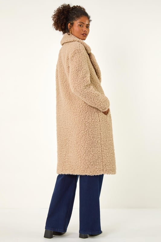 Dusk Borg Detail Longline Coat from Roman. Wrap up in style this Winter with this full-length Borg coat in classic biege. The soft Borg fabric provides ultimate warmth while the button detailing adds a touch of sophistication. Perfect for chilly days, this coat is ideal for layering over your favourite knitwear and jeans for a chic and cosy look that will keep you stylishly warm all season long!
