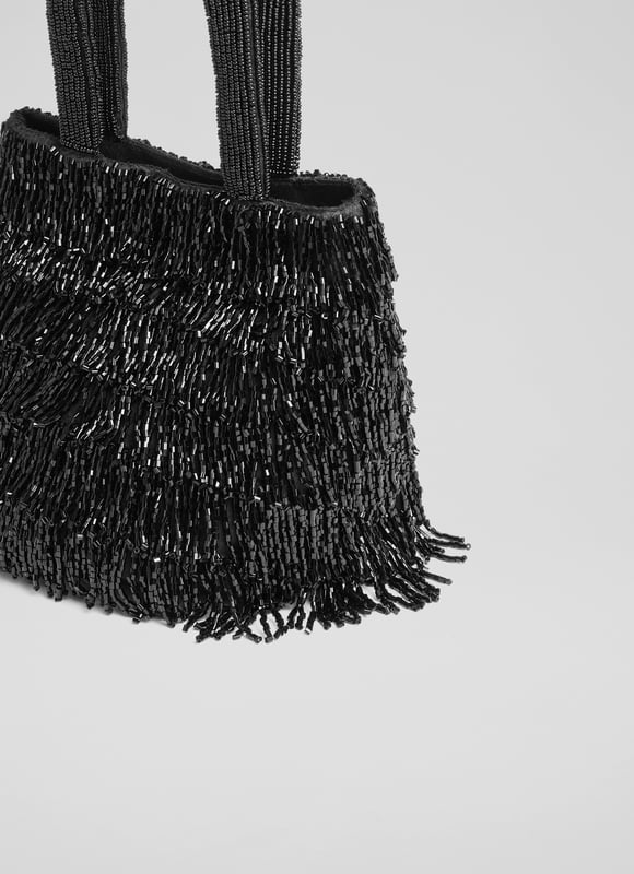 Shine in the spotlight with the dazzling Etsy clutch bag. Hand-beaded with intricate black crystals on mesh, this textured piece is lined with cotton for a luxurious touch. Perfect for evening events, pair the beaded bag with a sleek gown or tailored jumpsuit.