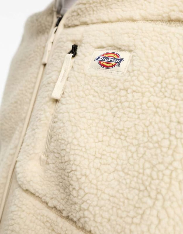Tops by Dickies Add-to-bag material V-neck Zip fastening Logo patch to chest Functional pockets Regular fit Unisex styleSold By: Asos