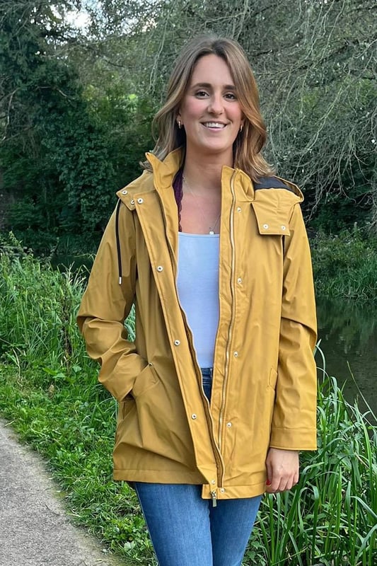 This waterproof jacket will keep you warm and dry with a lined hood, custom drawstring, and high neckline to keep the weather out. The quilted lining adds extra comfort while the zip-through fastening and press-stud storm flap provide additional protection. Made from high-quality PU, this jacket is both durable and stylish.

Rubberised waterproof fabric
Outer: 100% polyurethane, Lining 100% Polyester
Lined Hood

Zip and Popper Front Fastening
2 Front Pockets
28" Shoulder to Hem
Sizing: As expected¬†
Fit: Boxy