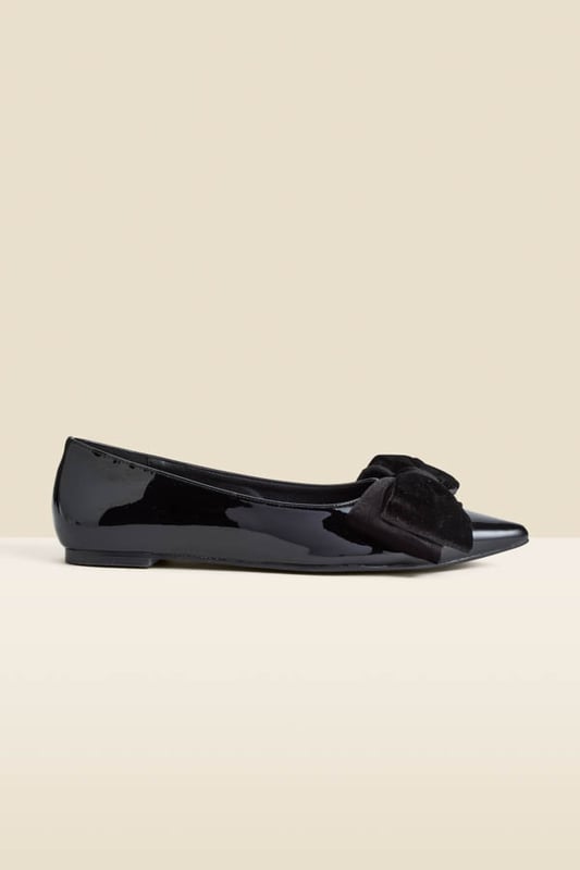 Who needs heels?Luxe patent leather for a hi-shine finish Adorned with a plush velvet bow Wear-forever pointed toe silhouette Flat sole so you can dance the night away We're styling them with wide-leg trousers and a sparkly top