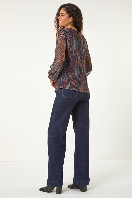 Shimmer Plisse Top from Roman. Unleash your style with our eye-catching geometric print plisse top, perfect for the Autumn Winter season. The classic round neckline and shirred cuffs offer a sophisticated touch, while the soft, shimmering fabric adds a hint of glamour. Pair with faux leather pants and ankle boots for a trendy party outfit!