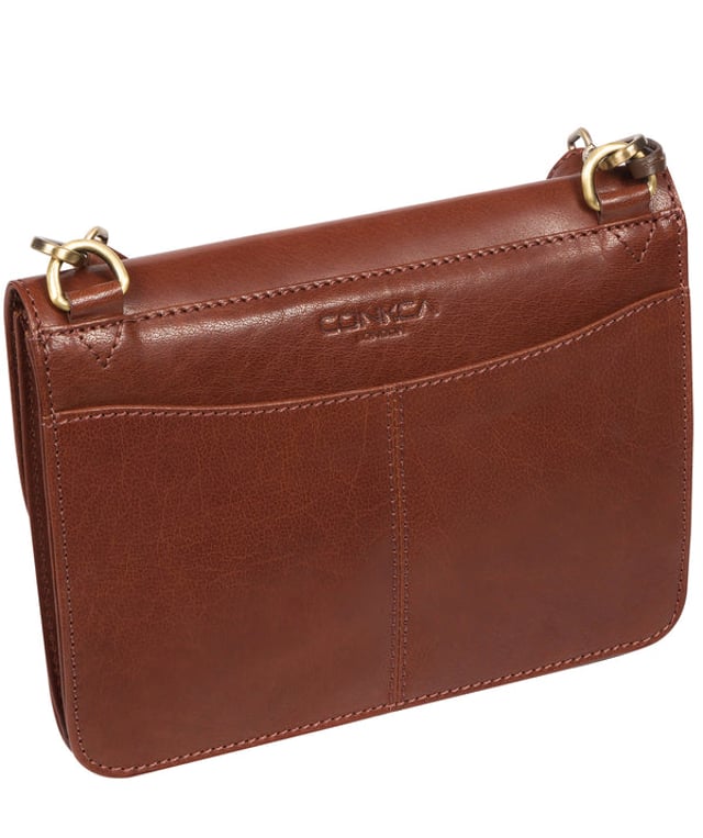 The 'Cara' cross body clutch bag from Conkca London is handcrafted from multi-toned leather for a beautiful finish. A magnetic press-stud secured cover opens to reveal the spacious interior that is lined with natural and untreated 100% cotton and includes two slip pockets. A full-width slip pouch on the rear of the bag is ideal for on-the-go storage. It comes with an adjustable leather strap with a maximum drop length of 70cm which is removable, converting the bag into a clutch bag. Adorned with the inimitable Conkca squirrel charm and metal logo.
