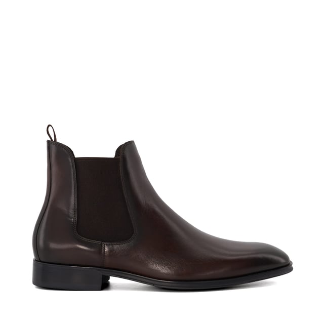 Dune Mens MANDATORY Chelsea Boots Mandatory Synonymous with Dune London, the Chelsea boot is a long-standing classic favoured for its transitional appeal. Signature style Mandatory perfectly blends a contemporary aesthetic with our iconic heritage. Crafted from the finest material and detailed with a quintessential elastic side gusset and grosgrain pull tab, this almond-toed silhouette has been set on a durable rubber outsole. Finished with tonal stitching, this timeless style will become a go-to dressing solution throughout the season.
