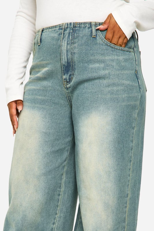 Wide-leg silhouette for a relaxed, on-trend look
        Vintage wash effect adds character and depth
        High-rise waist for a flattering fit
        Roomy pockets for practicality
        Versatile denim fabric suitable for various occasions
    
    Make a bold statement with these plus-size wide-leg jeans from Boohoo. The vintage wash lends a lived-in charm, perfect for achieving that coveted effortless style. The high-rise waist cinches you in at your smallest point, creating a flattering silhouette that pairs beautifully with both cropped tops and tucked-in blouses. For a casual daytime look, team with a simple white tee and trainers. When the evening calls, dress them up with a silky camisole and heeled mules. The roomy leg allows for maximum comfort and movement, ideal for family gatherings or casual Friday at the office. These jeans are a versatile wardrobe staple that can be styled countless ways, making them a must-have for the fashion-forward woman who values both style and comfort.