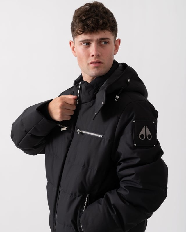 The Cloud Bomber boasts a 30% weight reduction compared to Moose Knuckles Originals, providing lasting warmth without added bulk. Crafted from lightweight shell and RDS-certified 90/10 down fill, it features a hollow frame logo for maximum warmth in a lightweight package. Its removable lamb shearling-trimmed hood adds versatility, while heat-retaining brushed pockets at the front enhance functionality.


Warmth & Protection


Protection Rating - Level 3: Crazy Cold – Heavy and durable, choose these garments when the cold gets serious.
800 Fill Power
Toscana Shearling on Trim
Water Repellent, Water Resistant, Wind Resistant




Design & Function


Capuchon amovible
Down Filled Collar
2- Way Zipper with Logo Puller
2 Pockets with Zipper Closure on Chest2 Pockets with Zipper Closure below Waist
Rib Knit Cuffs and Hem
Black Nickle Metal Logo


COMPOSITION



Body: 100% Polyester
Lining: 100% Polyester


FILL

90% Duck Down 10% Feathers
 
M34MB005S


 



 



 