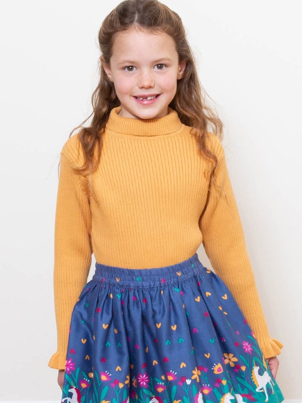 Enjoy all the practicality of a top plus the warmth and comfort of a jumper with this choice. Featuring a gorgeous butterscotch rib knit, roll neck and frill cuff detail, this piece of organic knitwear goes perfectly with so many of Kite's skirts, dresses and more.