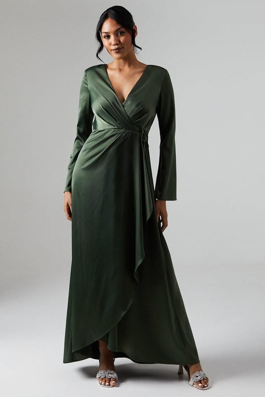 Elegant wrap neckline for a flattering silhouette
        Long sleeves with subtle flare for graceful movement
        Luxurious satin fabric that drapes beautifully
        Waterfall detail adds a touch of romance
        Floor-length design perfect for formal occasions
    
    This stunning Debut London by Coast bridesmaids dress radiates sophistication and grace. The wrap neckline creates a flattering V-shape, while the long sleeves with a subtle flare add an element of elegance. The satin fabric drapes exquisitely, creating a smooth and polished look that's perfect for wedding celebrations. The waterfall detail adds a romantic touch, ensuring you'll stand out in all the right ways. Pair with delicate drop earrings and a sleek updo to complete your bridal party ensemble. This dress is designed to complement the bride while allowing you to shine in your supporting role. Its versatile style ensures you'll feel confident and beautiful throughout the entire wedding day, from the ceremony to the last dance.