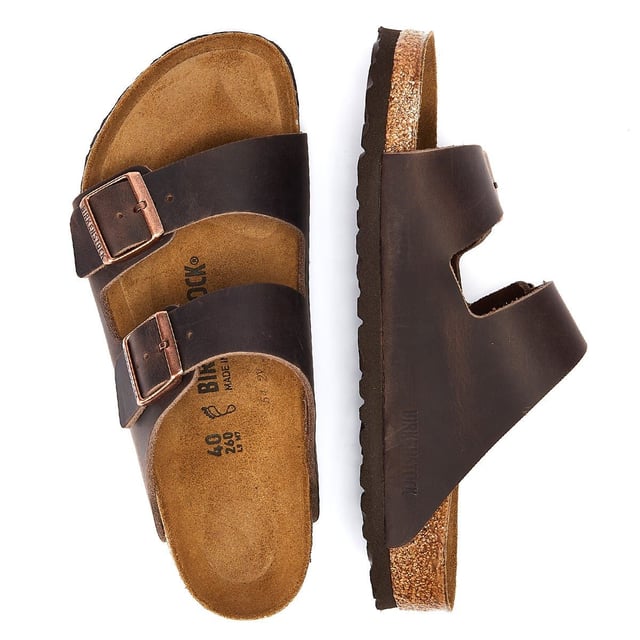 Birkenstock Arizona Habana Unisex Sandals The Birkenstock Arizona SFB Unisex Tabaco Brown Sandals are sandals feature two adjustable straps with metallic buckles that can be customized to fit the foot comfortably.The upper material is made of oiled nubuck leather which is durable and easy to maintain. The leather also has a soft velvety texture that feels comfortable against the skin. The footbed of the Birkenstock Arizona SFB Sandals is made of the brand's signature cork-latex material which is anatomically shaped to support the foot's natural contours. The footbed also has a deep heel cup a roomy toe box and a suede lining that helps wick away moisture keeping the feet cool and dry. The sole of the Birkenstock Arizona SFB Sandals is made of EVA a lightweight and flexible material that provides cushioning and shock absorption.