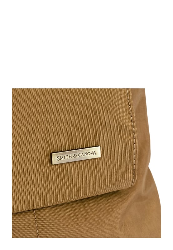 Made from our signature nylon, the Portrait Nylon Tote is the perfect way to carry all your everyday essentials. Featuring a padded carry handle and adjustable crossbody strap with a clip off function. Features: , Zip top opening, Front oversized flap over zip pocket, Rear zip pocket, SMITH & CANOVA antique brass logo, Branded antique brass zips, Padded grab handle, Adjustable crossbody strap (detachable), Internal 15 inch padded laptop sleeve, Internal zip pocket, 2 Internal mobile phone slip pockets - fits normal and plus size smart phones, 2 Internal pen slip pockets Style Ref: 92682 TAN