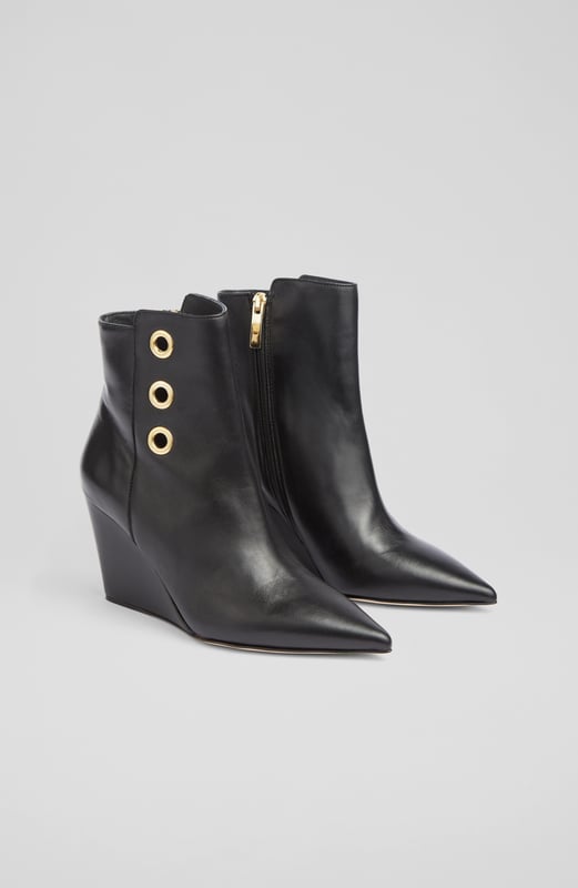 LK Bennett Brie Ankle Boots,Black A stand-out pair of ankle boots in our new collection, the Brie boots offer wear-all-day comfort and contemporary chic in equal measure. Beautifully made in Italy from buttery soft black nappa leather, they have a pointed toe, gold eyelet detail, an inside zip and a leather wedge 80mm heel. Sleek and sexy, slip them on with dresses and skirts as well as smarter, more tailored looks.